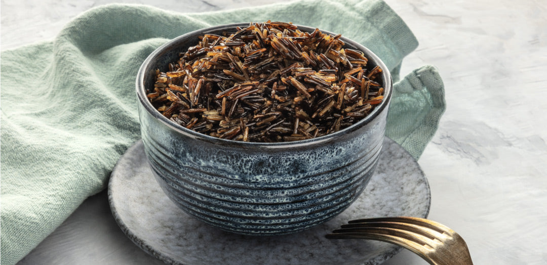 bowl full cooked organic minnesota wild rice on a dinner table